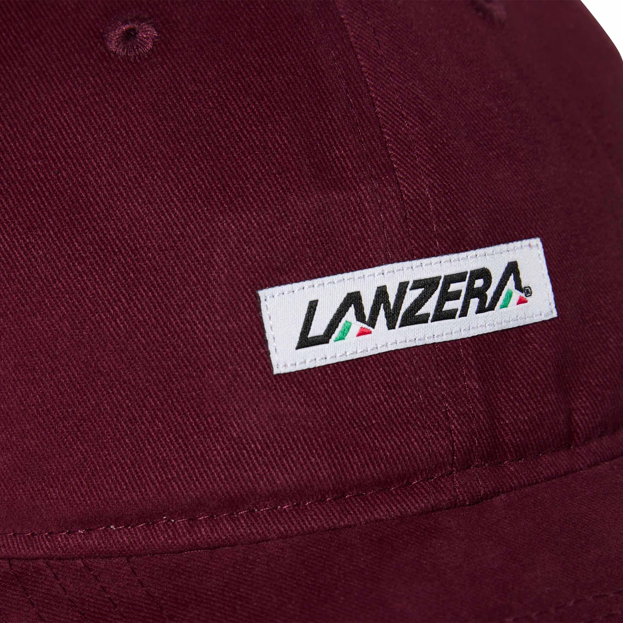 Close-up of the Lanzera Club Cap in Burgundy showing the stitched Lanzera club patch with red, green, and black detailing.