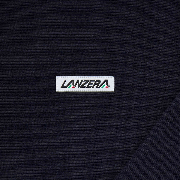 Close-up of Lanzera logo patch on Club Crewneck sweatshirt in Navy Clásico.