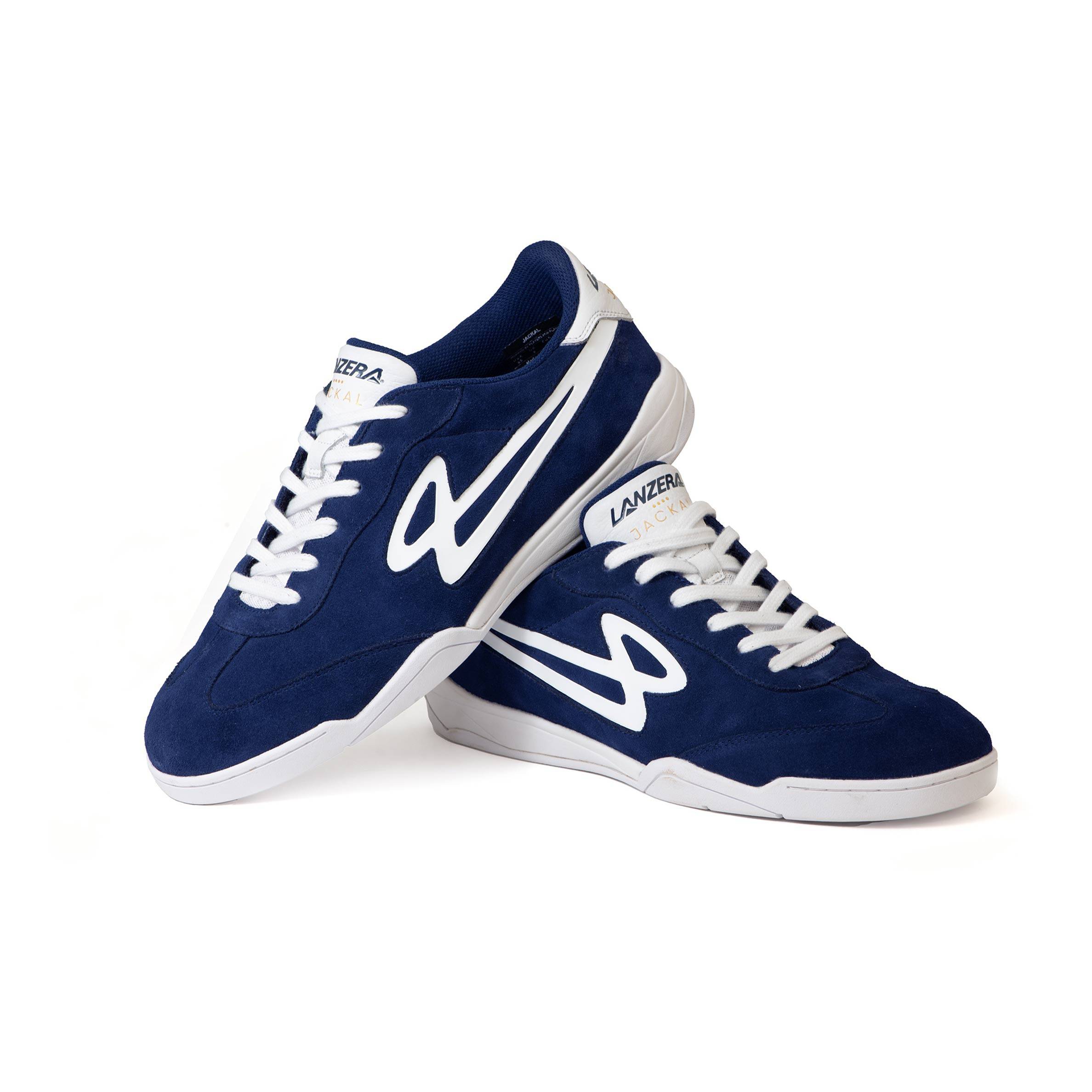 Stacked Lanzera Jackal Navy soccer shoes showing suede uppers and white logo.
