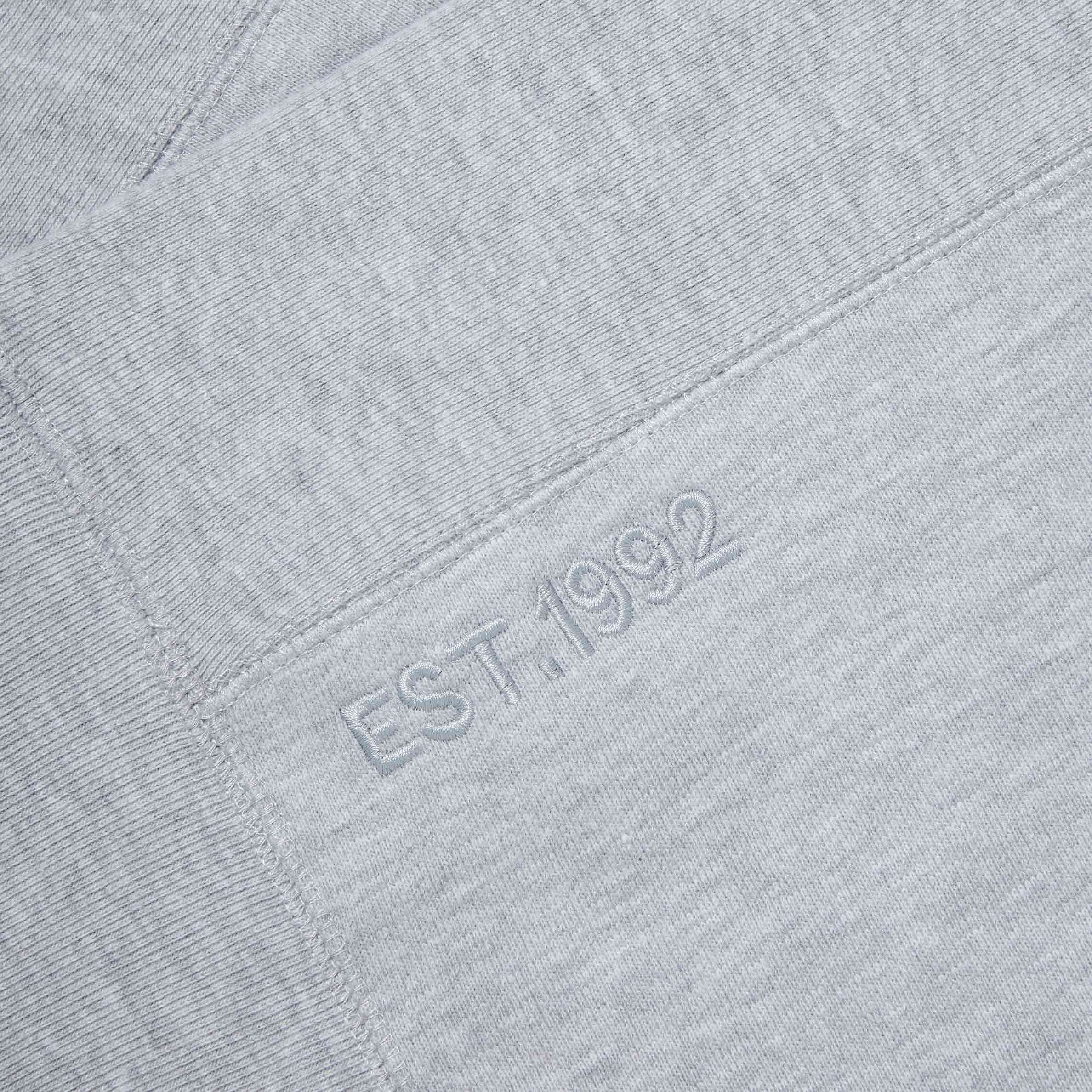 Detailed shot of the 'EST. 1992' embroidery on the Lanzera Club Crewneck in Grey heather, celebrating Lanzera’s legacy in football culture with tonal stitching for a sophisticated touch.