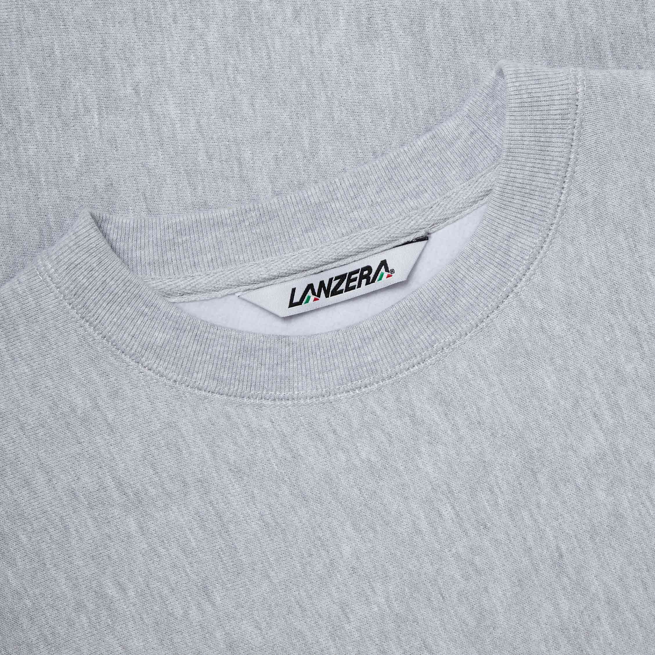 A close-up of the Lanzera Club Crewneck’s woven neck label, highlighting the brand’s Italian-inspired identity. Premium grey heather cotton. Designed for those who live and breathe the game.