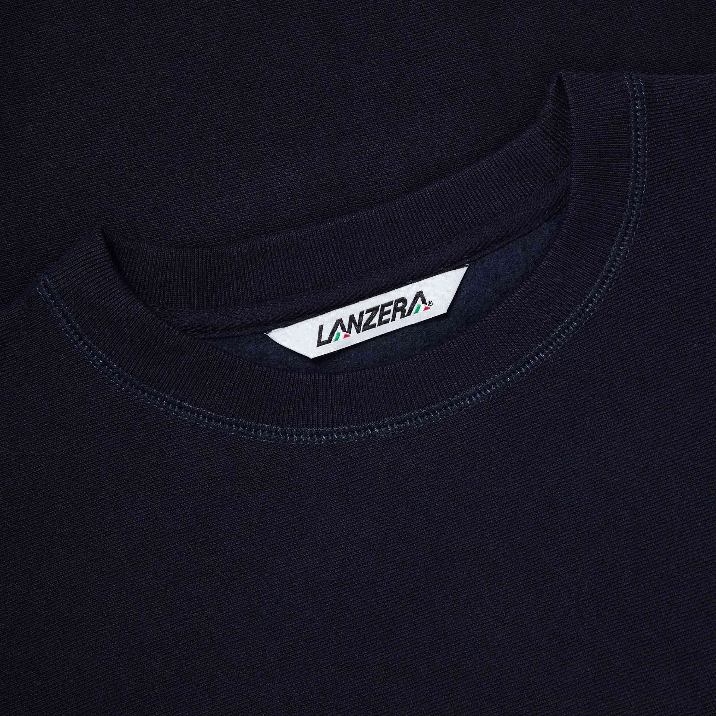 Close-up of the Lanzera Club Crewneck in Navy Clásico, highlighting the ribbed collar and inner neck tag. The refined stitching and soft fabric offer a premium feel, while the Lanzera label reinforces the brand’s timeless approach to football-inspired apparel.