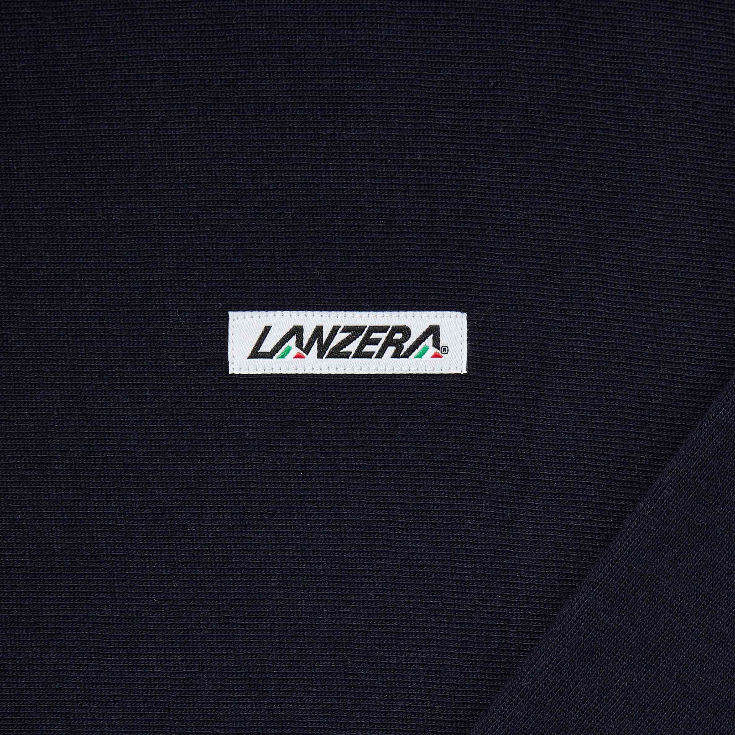 Close-up of the Lanzera embroidered logo patch on the Club Hoodie in Navy Clásico, highlighting the detailed craftsmanship and minimalist branding.