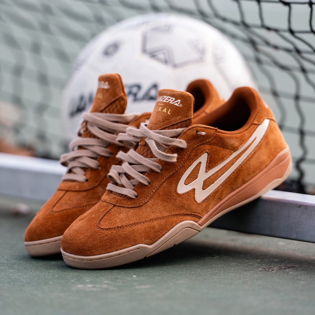 Lanzera Jackal sneakers in Caramello brown with a visible brand logo in a futsal goal in background