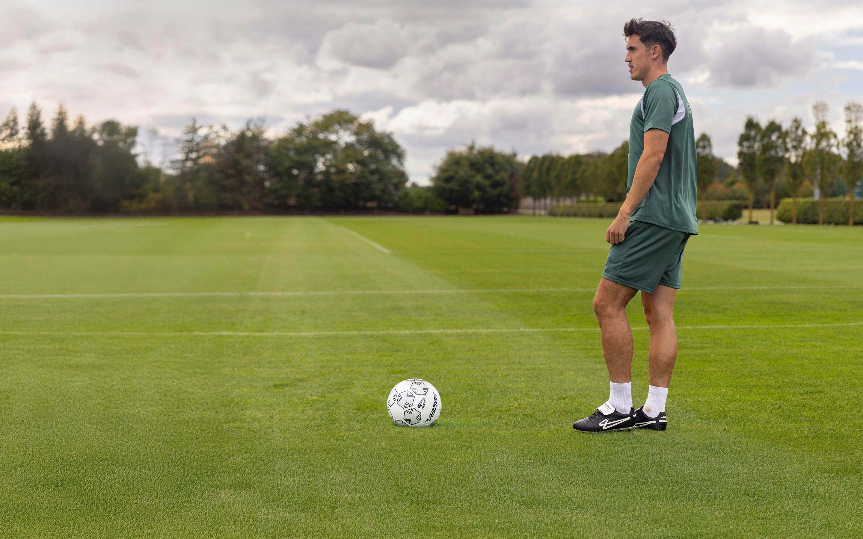 Football player wearing Lanzera Professionale K-leather cleats on a football field.